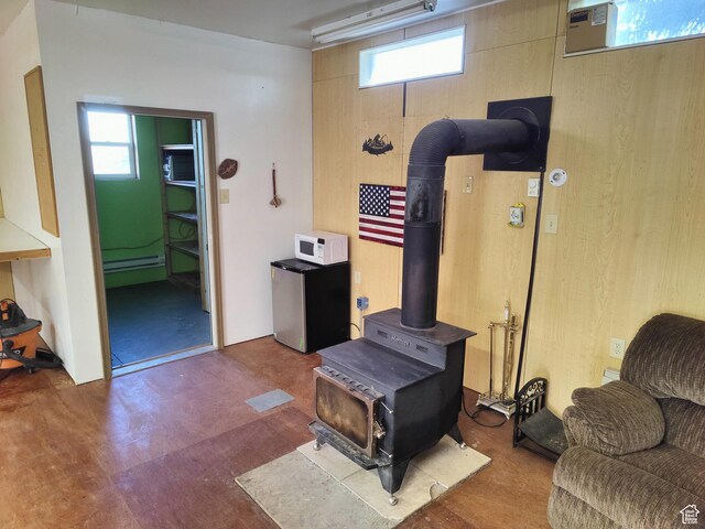 124 N Lakeview Dr, Manila, UT 84046 - living area featuring baseboard heating and a wood stove