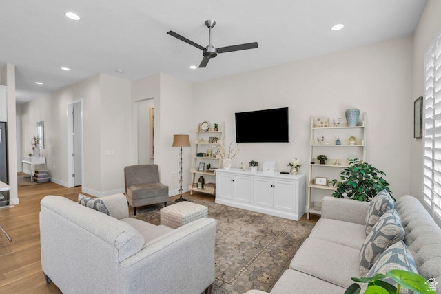 living room with baseboards, recessed lighting, a ceiling fan, and light wood finished floors