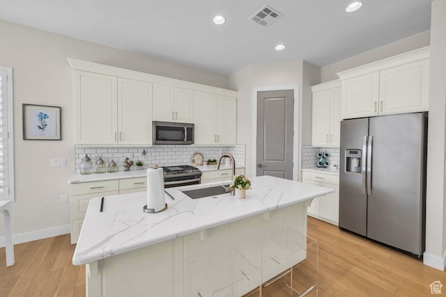 kitchen featuring a sink, visible vents, white cabinets, and appliances with stainless steel finishes