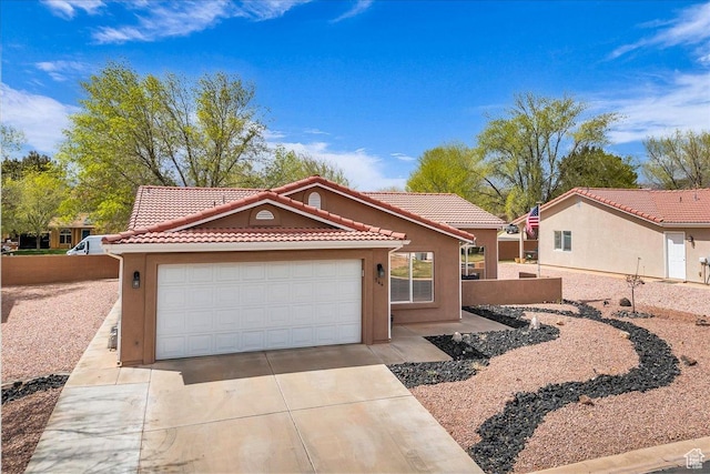 544 S Fiesta Dr, Ivins, UT 84738 - view of front of property with a tile roof, a garage, driveway, and stucco siding