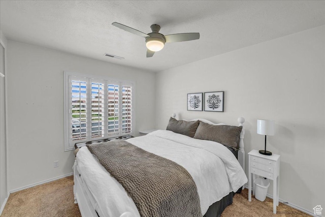 544 S Fiesta Dr, Ivins, UT 84738 - bedroom featuring carpet floors, a textured ceiling, visible vents, and a ceiling fan
