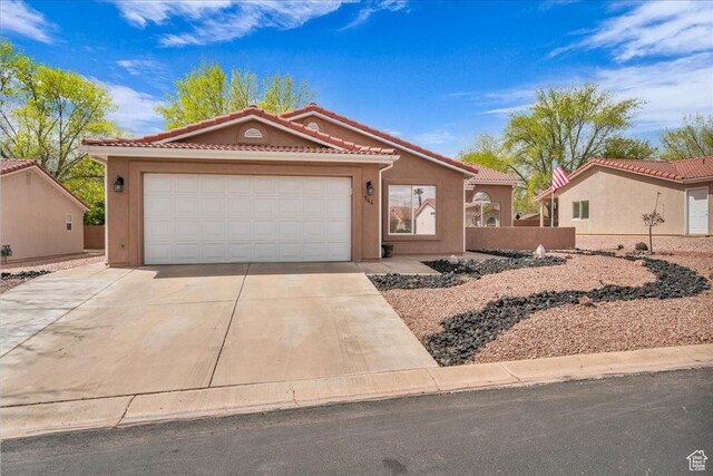 544 S Fiesta Dr, Ivins, UT 84738 - mediterranean / spanish home featuring stucco siding, an attached garage, a tiled roof, and concrete driveway