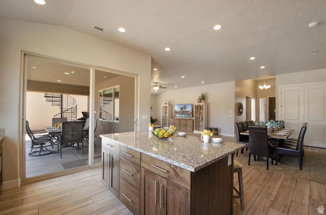 3823 W Dream Cir Unit 120, Santa Clara, UT 84765 - kitchen featuring recessed lighting, lofted ceiling, a kitchen bar, and wood tiled floor