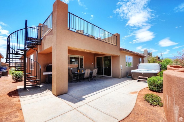 3823 W Dream Cir Unit 120, Santa Clara, UT 84765 - rear view of house with stairs, stucco siding, a patio area, and a hot tub