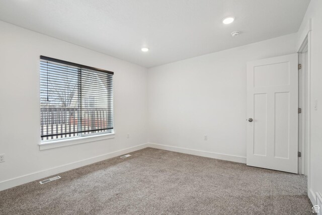 spare room featuring recessed lighting, visible vents, baseboards, and carpet floors