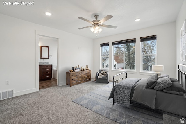 carpeted bedroom with baseboards, recessed lighting, ensuite bathroom, a ceiling fan, and visible vents