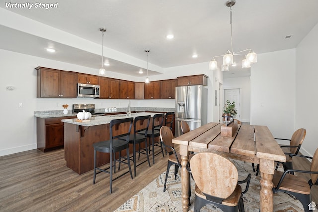dining room with recessed lighting, visible vents, baseboards, and wood finished floors