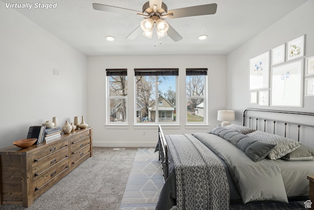carpeted bedroom featuring baseboards, a ceiling fan, and recessed lighting