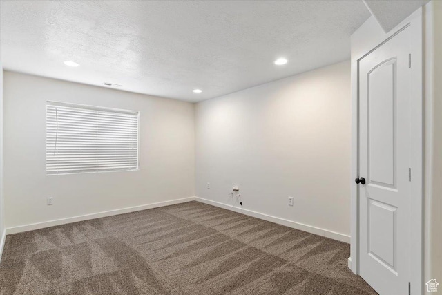 carpeted spare room with baseboards, recessed lighting, and a textured ceiling