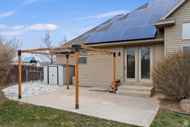 view of patio / terrace with a storage unit, fence, entry steps, and an outdoor structure
