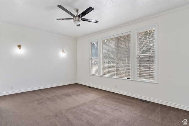 empty room featuring visible vents, crown molding, carpet flooring, and a ceiling fan