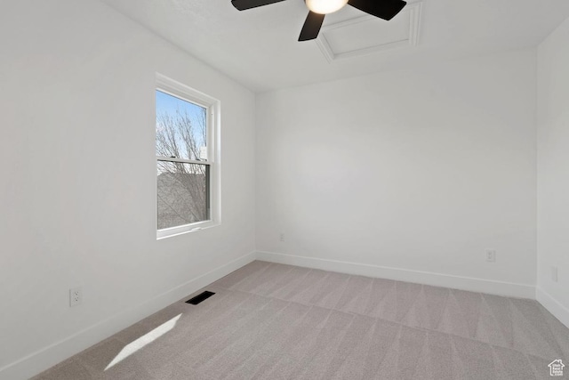 spare room with attic access, baseboards, ceiling fan, visible vents, and light carpet