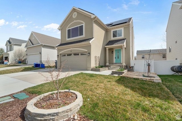 traditional home featuring concrete driveway, stucco siding, an attached garage, fence, and roof mounted solar panels