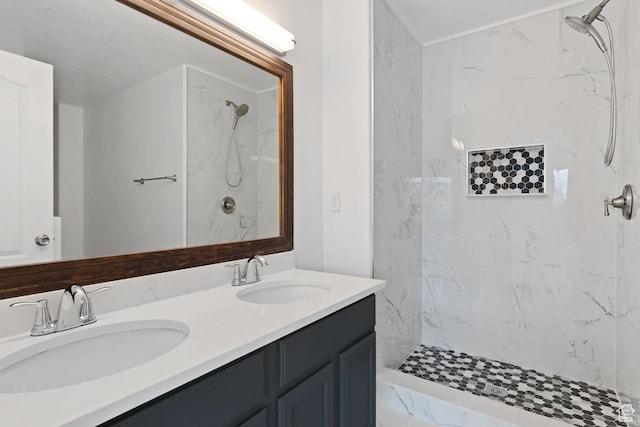 bathroom featuring double vanity, a sink, and a marble finish shower