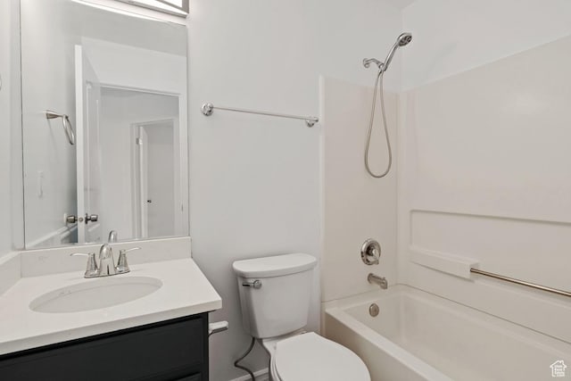 bathroom with toilet, vanity, and washtub / shower combination