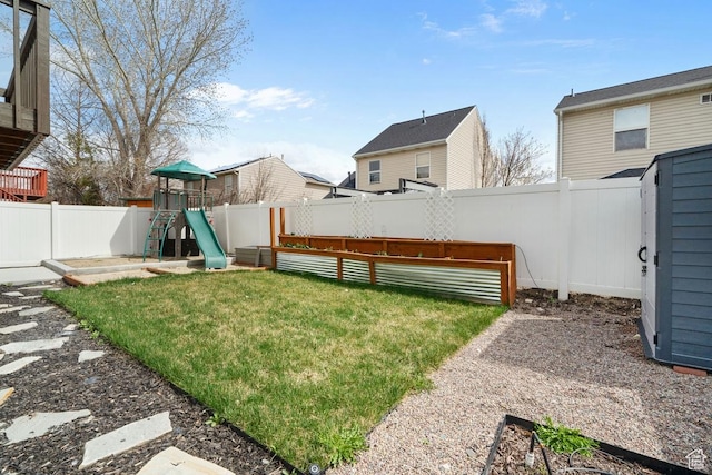 view of yard featuring a fenced backyard and a playground