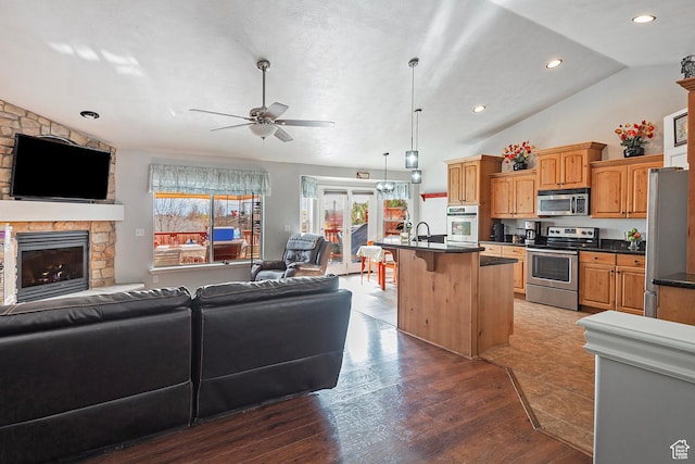 1288 S Pondside Dr, Saratoga Springs, UT 84045 - interior space with ceiling fan, wood finished floors, recessed lighting, a stone fireplace, and lofted ceiling