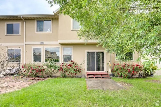1784 W Grays Pl, Lehi, UT 84043 - rear view of house featuring stucco siding, a patio, entry steps, and a yard