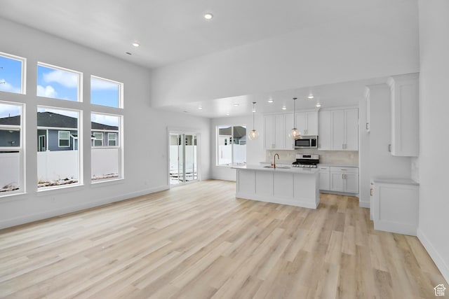 2351 W 2950 N Unit 104, Farr West, UT 84404 - kitchen with white cabinets, a sink, plenty of natural light, and appliances with stainless steel finishes