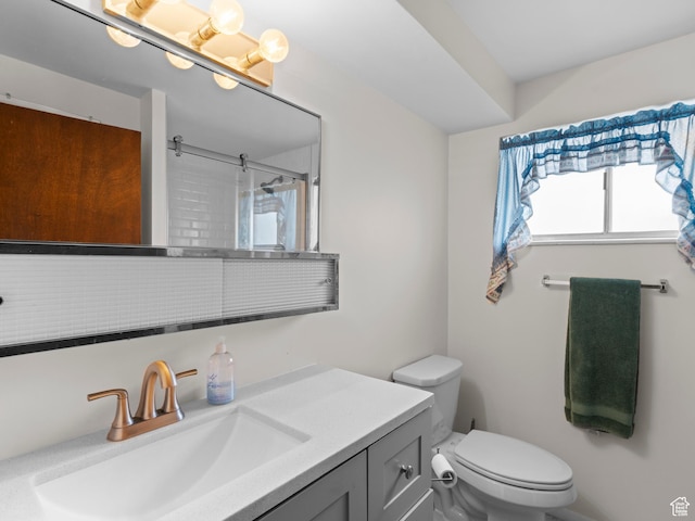 bathroom with toilet, a shower, and vanity