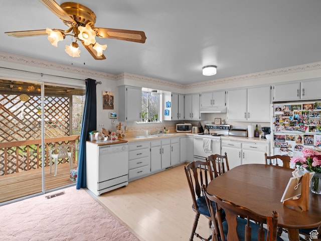 kitchen with light countertops, visible vents, white appliances, a ceiling fan, and under cabinet range hood