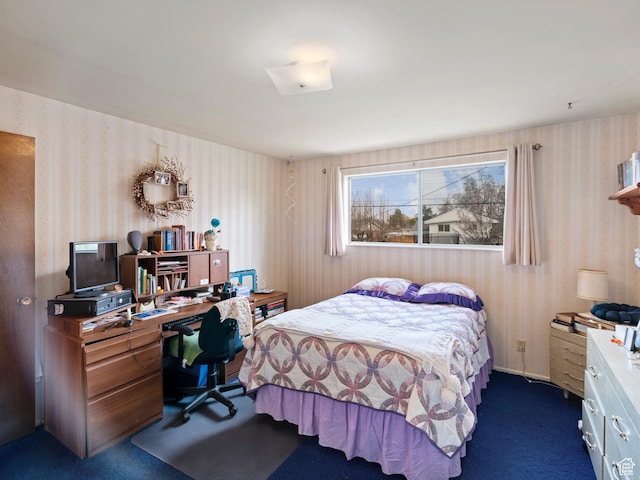 bedroom featuring wallpapered walls and dark carpet
