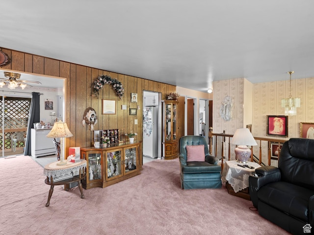 carpeted living room with a ceiling fan and baseboard heating