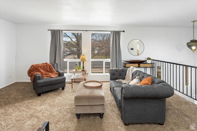 carpeted living area featuring baseboards