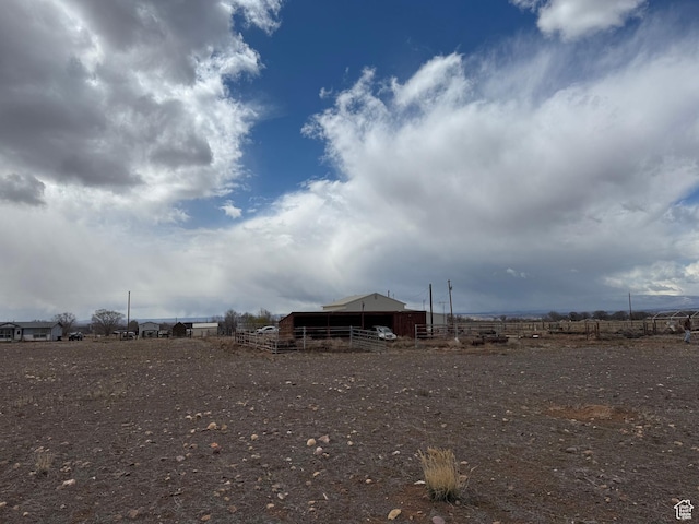 6051 N 11500 E, Lapoint, UT 84039 - view of yard featuring an outbuilding, fence, a pole building, and a rural view