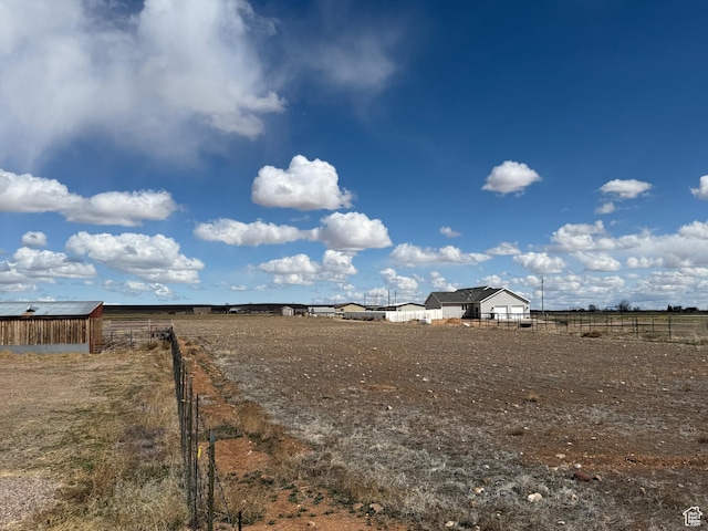6051 N 11500 E, Lapoint, UT 84039 - view of yard featuring an outbuilding, fence, and a rural view