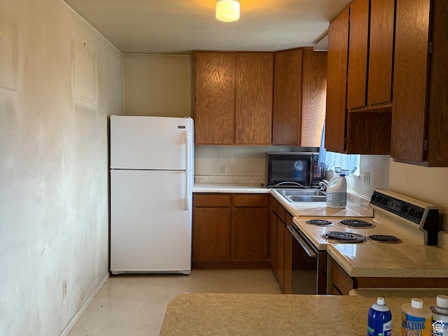 6051 N 11500 E, Lapoint, UT 84039 - kitchen with light countertops, a sink, range with electric stovetop, freestanding refrigerator, and brown cabinets