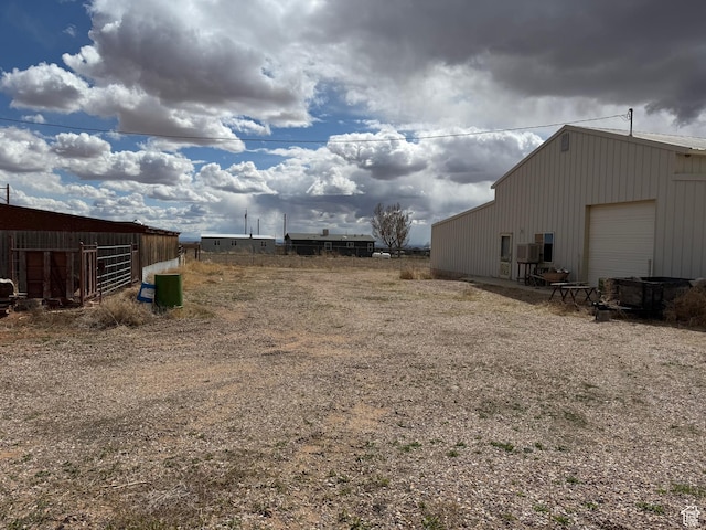 6051 N 11500 E, Lapoint, UT 84039 - view of yard with an outbuilding, a garage, and a pole building
