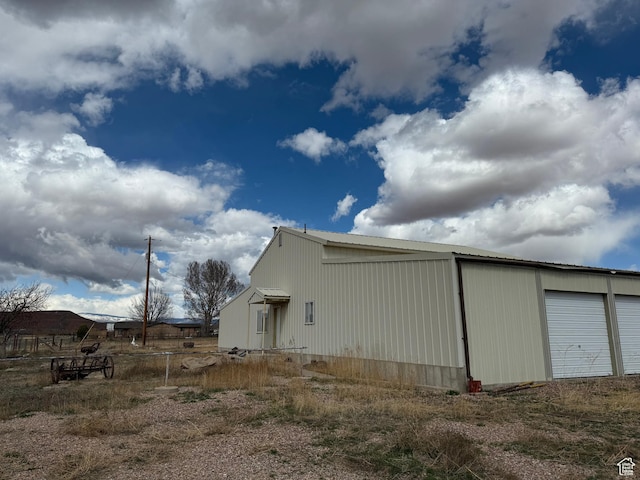 6051 N 11500 E, Lapoint, UT 84039 - view of property exterior with a garage and metal roof