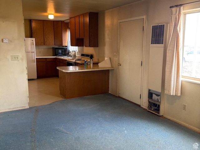6051 N 11500 E, Lapoint, UT 84039 - kitchen with range with electric stovetop, brown cabinets, a peninsula, and freestanding refrigerator
