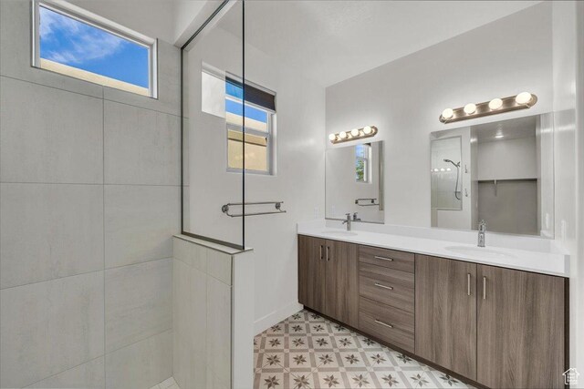 3150 Fuchsia Dr, St George, UT 84790 - full bathroom with tile patterned floors, double vanity, a sink, and walk in shower