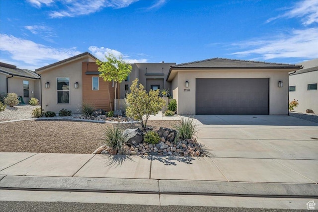 ranch-style house featuring concrete driveway, stucco siding, a tiled roof, and a garage