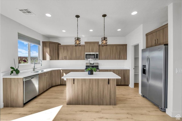 3150 Fuchsia Dr, St George, UT 84790 - kitchen featuring light countertops, a center island, visible vents, stainless steel appliances, and a sink