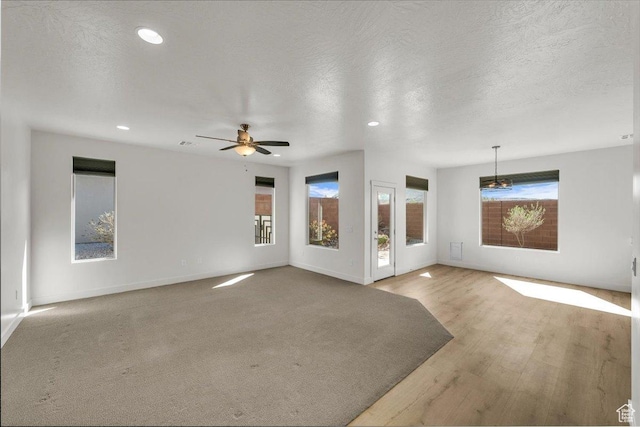 3150 Fuchsia Dr, St George, UT 84790 - unfurnished living room featuring a wealth of natural light, recessed lighting, baseboards, and a ceiling fan