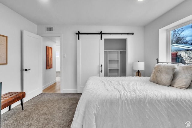 4970 S 4720 W, Salt Lake City, UT 84118 - bedroom with baseboards, a barn door, visible vents, and carpet floors