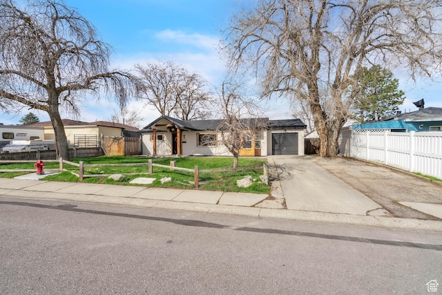 4970 S 4720 W, Salt Lake City, UT 84118 - mid-century inspired home featuring a front yard, a fenced front yard, a garage, and concrete driveway