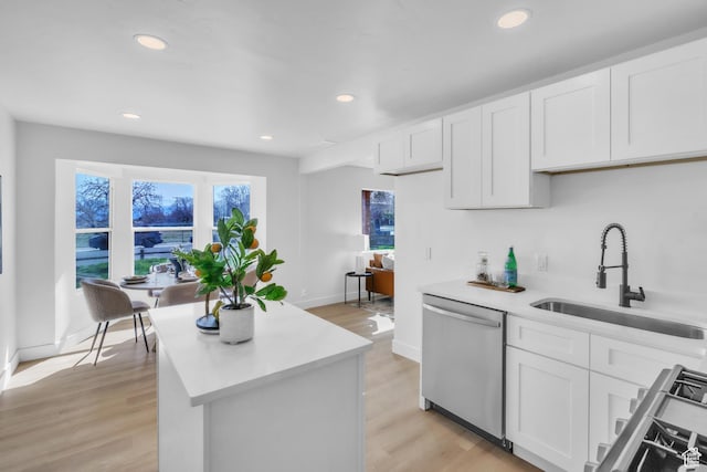 4970 S 4720 W, Salt Lake City, UT 84118 - kitchen featuring light countertops, a sink, light wood finished floors, stainless steel dishwasher, and range