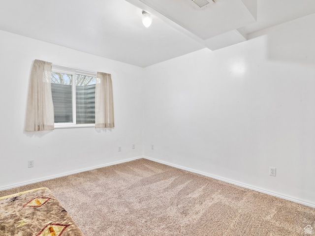 carpeted empty room with baseboards