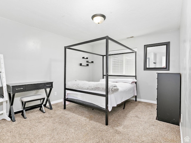 bedroom with baseboards, visible vents, and carpet flooring