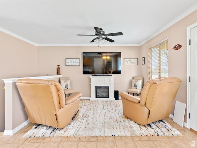 living room with baseboards, ceiling fan, ornamental molding, and a glass covered fireplace