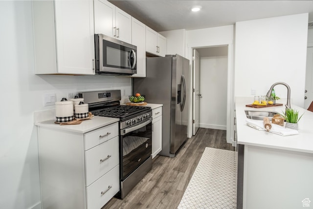 3440 W Mitchell Dr, Lehi, UT 84043 - kitchen featuring light countertops, a sink, white cabinets, appliances with stainless steel finishes, and wood finished floors