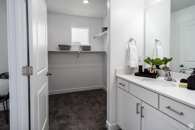 3440 W Mitchell Dr, Lehi, UT 84043 - bathroom with baseboards, a walk in closet, and vanity