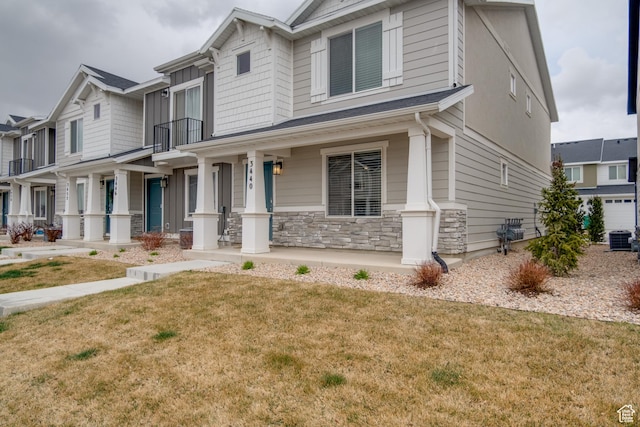 3440 W Mitchell Dr, Lehi, UT 84043 - craftsman-style home with a front yard, stone siding, a balcony, a porch, and central AC
