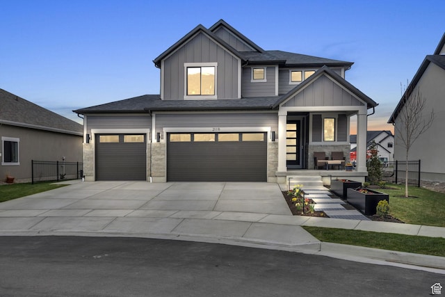 2119 N 520 W, Centerville, UT 84014 - view of front of property with a garage, fence, board and batten siding, a porch, and driveway