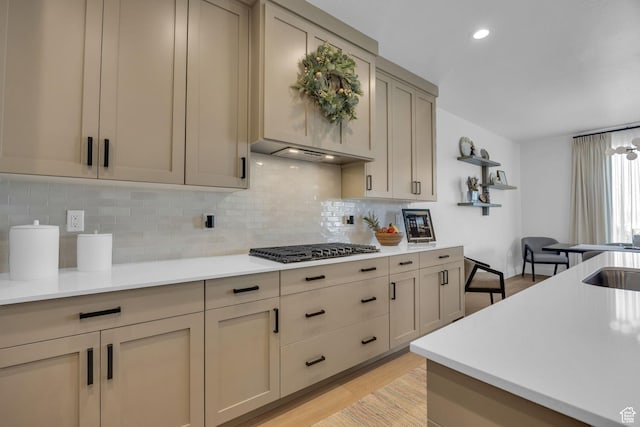 2119 N 520 W, Centerville, UT 84014 - kitchen with light wood-type flooring, decorative backsplash, gas stovetop, and light countertops