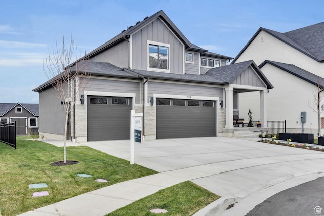 2119 N 520 W, Centerville, UT 84014 - view of front of house with fence, stone siding, board and batten siding, a front yard, and concrete driveway